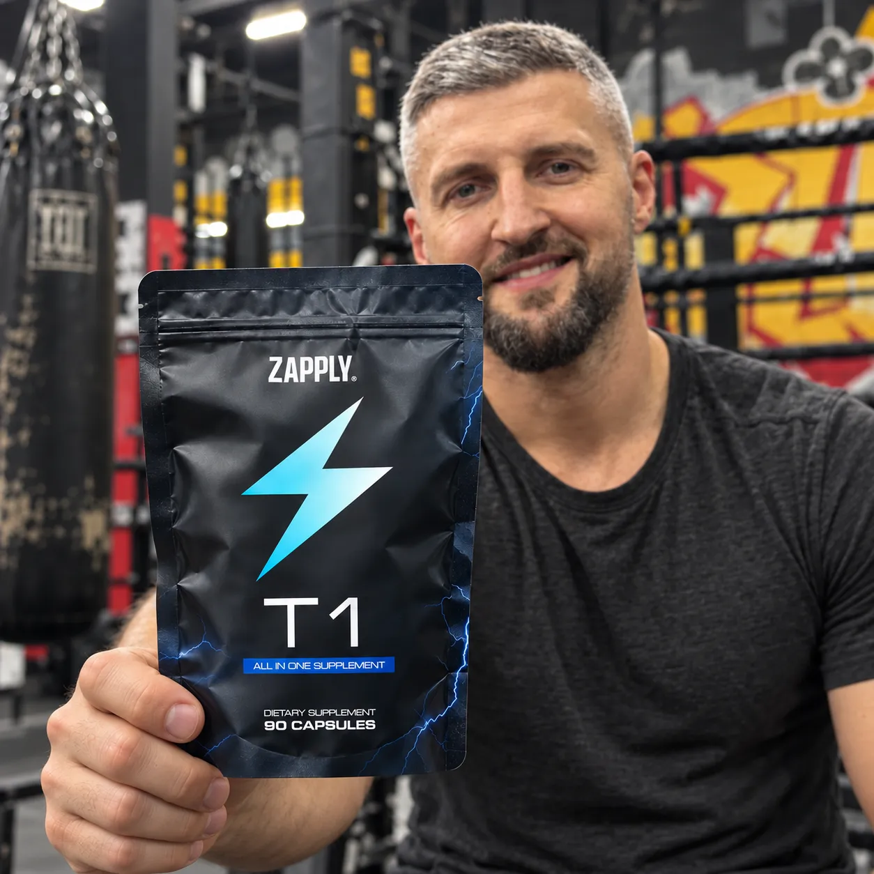 Hand holding the Testo Charge Capsules pouch in the gym